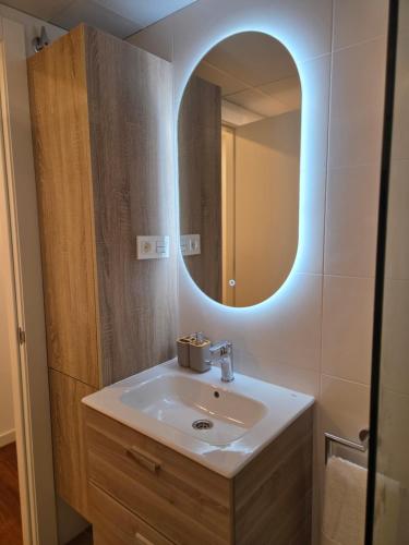 a bathroom with a sink and a mirror at Solsuites in Almería