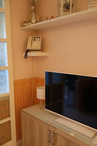 a flat screen tv sitting on top of a cabinet at Maison Prestige in Monfalcone