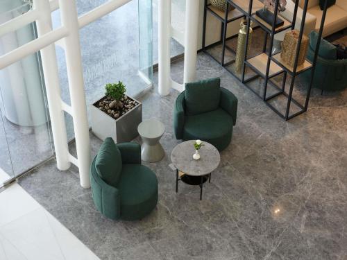 an overhead view of a lobby with chairs and a table at Novotel Riyadh Al Anoud in Riyadh