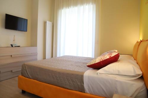 a bedroom with a bed with two pillows and a window at Domus Marina - Ionio room in Mondragone