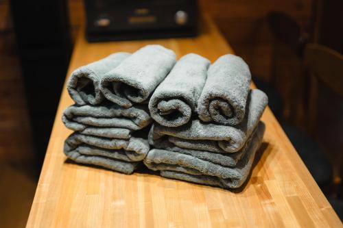 a pile of towels sitting on a table at KAGUYA Karuizawa - 輝屋 in Naganohara