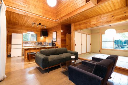 a living room with a couch and a table at KAGUYA Karuizawa - 輝屋 in Naganohara