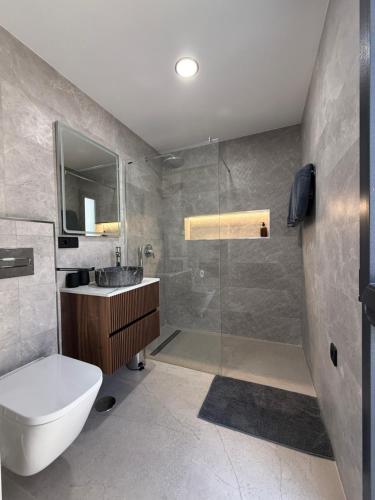 a bathroom with a toilet and a sink and a shower at Villa Jupiter by Albir Proper Properties in Albir