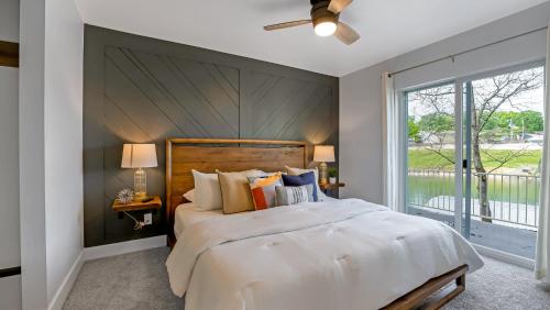 a bedroom with a large bed and a large window at Amazing Lakefront Paradise with Perfect Location in Osage Beach