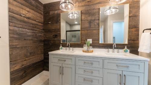 a bathroom with two sinks and a mirror at Amazing Lakefront Paradise with Perfect Location in Osage Beach