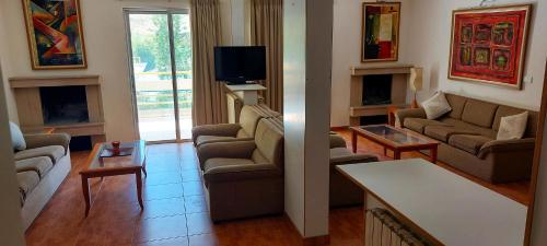 a living room with two couches and a tv at 4-Bedroom chalet for Ski and Summer in Kfardebian