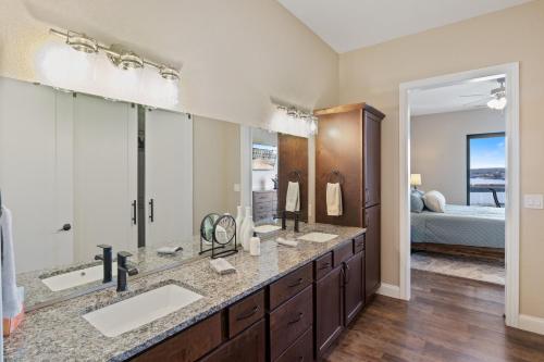 a bathroom with two sinks and a large mirror at Brand New Complex, Central Location, Amazing Views in Laguna Beach