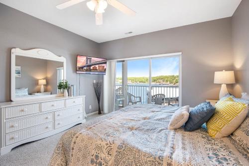 a bedroom with a bed with a dresser and a mirror at Experience Lakeside Living at Its Finest: Stunning Views and Prime Location! in Laguna Beach