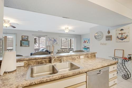 a kitchen with a sink and a counter top at Close to The Strip, Private Dock & Screened Deck! in Lake Ozark