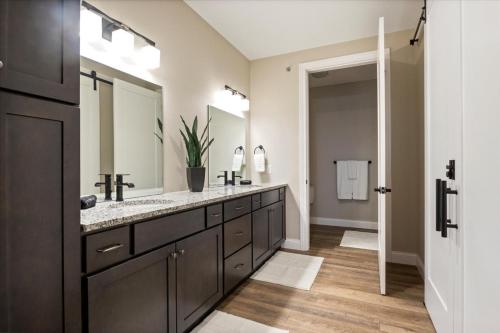 a bathroom with two sinks and a large mirror at Family-Fun Lakeside Luxury at Topsider in Osage w/ 2 Pools, Prime Views Pack N' Play & Games in Laguna Beach