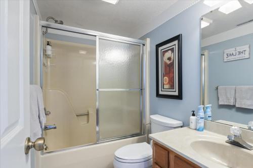 a bathroom with a shower and a toilet and a sink at Family Fun at Lake Vibin' Lazy Days Osage Beach w/ 2 Pools, Playground, Games & Calm Water in Damsel