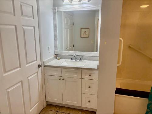 a bathroom with a sink and a mirror at Ocean Walk Resort - Fabulous Ocean Front View in Daytona Beach