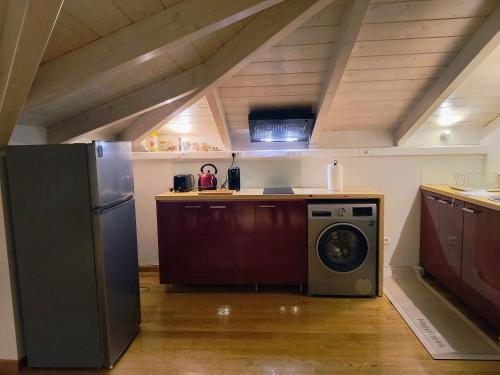 a kitchen with a refrigerator and a washing machine at La Loft Luxury Appartment in Preveza