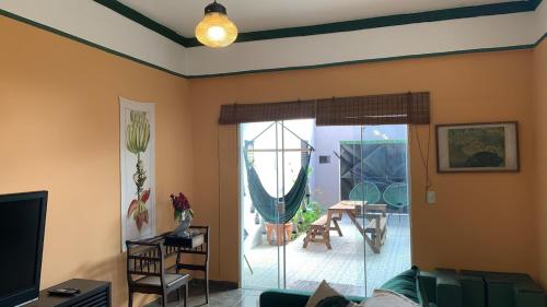 a living room with a couch and a sliding glass door at House with Jacuzzi near São Paulo in Piracaia