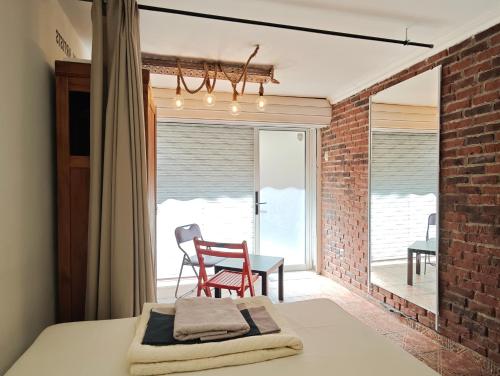 a bedroom with a bed and a table and a chair at Interhost Guest rooms and apartments in Sofia