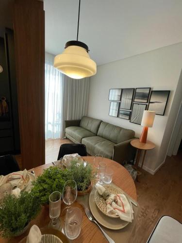a living room with a table and a couch at Apartamento Novo - Conforto no Saguaçú! in Boa Vista