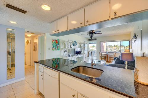 a kitchen with a sink and a living room at Waterfront Views and Pool Access Punta Gorda Escape in Burnt Store Marina
