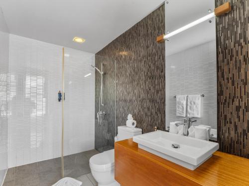 a bathroom with a sink and a toilet and a shower at Stay at Ultravioleta Cabarete Beachfront Apartments by EvoKey in Cabarete