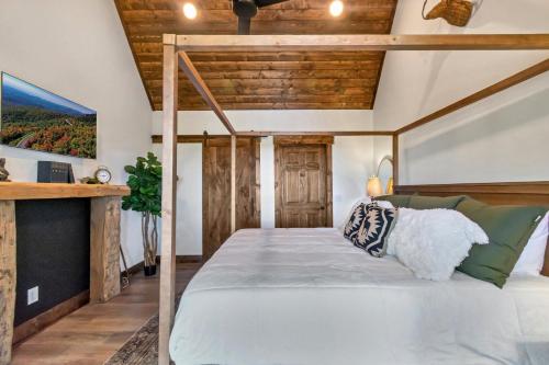 a bedroom with a bed with a wooden ceiling at Beech Blessings in Beech Mountain