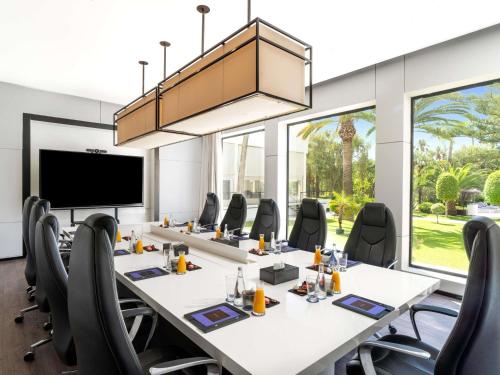 a conference room with a long table and chairs at Sofitel Rabat Jardin Des Roses in Rabat