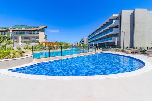 a swimming pool in front of a building at Beach Class Summer resort condominium by Carpediem in Porto De Galinhas