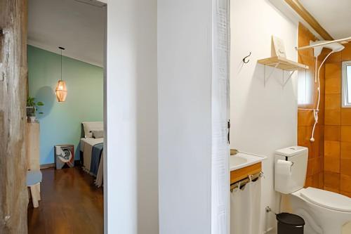 a bathroom with a sink and a toilet in a room at CASA TUPI in Ubatuba