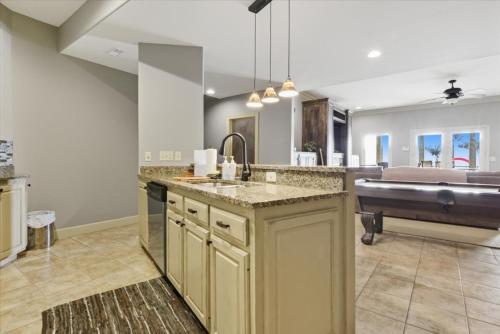 a large kitchen with a sink and a tub at Luxury Lakefront Escape w/ Heated Pool, Hot Tub & Theater in Sunrise Beach
