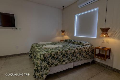 En eller flere senge i et værelse på Flat Vila Maria