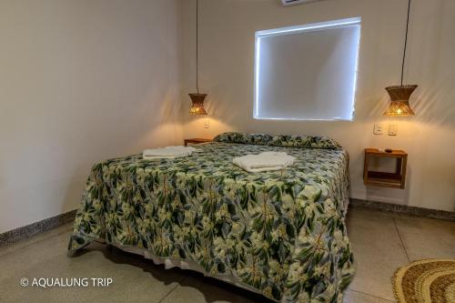 En eller flere senge i et værelse på Flat Vila Maria