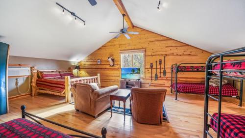 a room with bunk beds in a cabin at Hot Tub, Fire Pit, Awesome Loft & Amazing Views! in Buck Creek