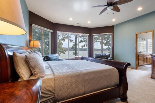 a bedroom with a bed and a ceiling fan at Pet-Friendly Home In The Main Channel w/ Breathtaking Sunsets & Lake Views in Lake Ozark