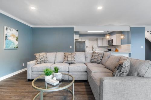 a living room with a couch and a table at Our Cove Retreat - Perfect for Wave-Free Swimming, Tanning & Prime Location Fun! in Lake Ozark