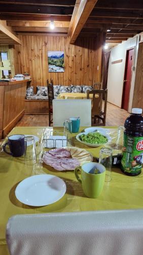 a table with plates of food on top of it at La Casa de Coke in Hualaihué