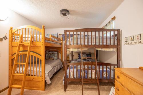 a bedroom with two bunk beds and a bed at Wonderful Remote Lake Cabin! Fish from Deck & Dock in Rocky Mount