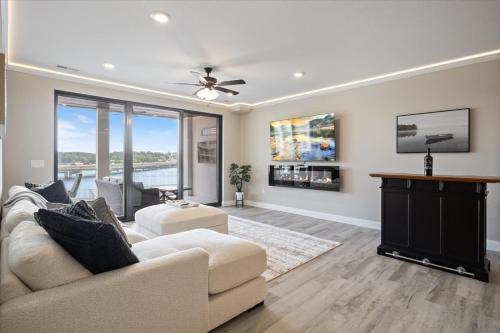 a living room with a couch and a ceiling fan at Lakefront Topsider Condo w/ Boat Slip, 2 Pools & Large Deck in Laguna Beach