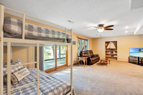 a bedroom with bunk beds and a living room at Ideal Cove with Amazing Dock, Kayaks & Fire Pit in Sunrise Beach