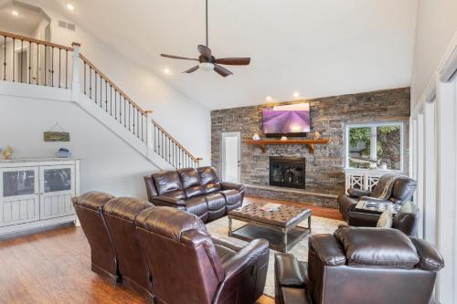 ein Wohnzimmer mit Ledermöbeln und Kamin in der Unterkunft Incredible Views, Spacious Deck, Private Dock, Gas Grill, Games & Cards in Buck Creek