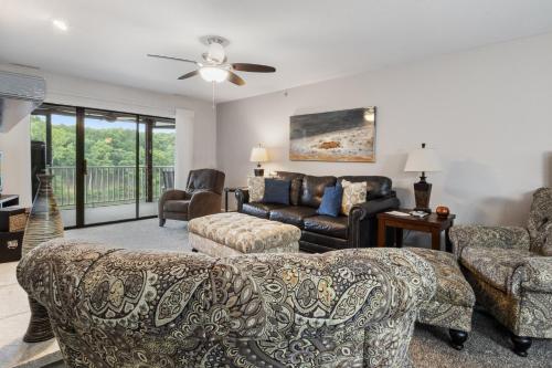a living room with a couch and chairs at LazyDays Pet-Friendly Condo w/ Pool & Slip at 3M in Damsel