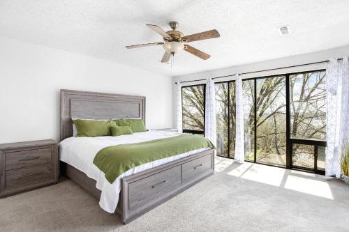 a bedroom with a bed and a ceiling fan at Treetop Vibes on Horseshoe Bend in Four Seasons