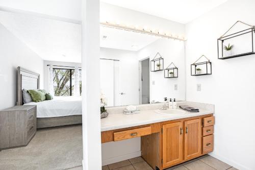 a bathroom with a sink and a bedroom with a bed at Treetop Vibes on Horseshoe Bend in Four Seasons