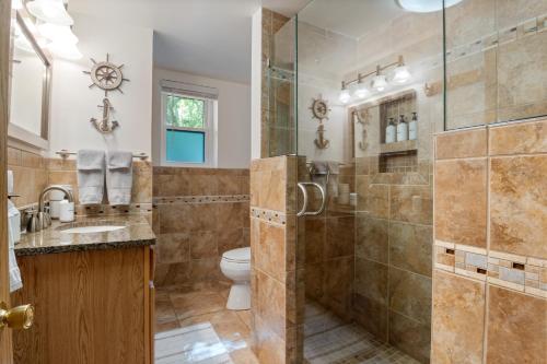 a bathroom with a shower and a toilet at Spacious, Quiet & Great Cove, Nearby Attractions, Private Dock, Fireplace, Expansive Deck in Rocky Mount