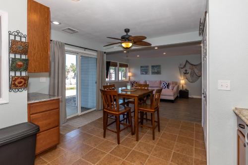 a kitchen and dining room with a table and chairs at Pet-Friendly Condo at MM-19 w/ Boat Slip & Lake Views in Laguna Beach