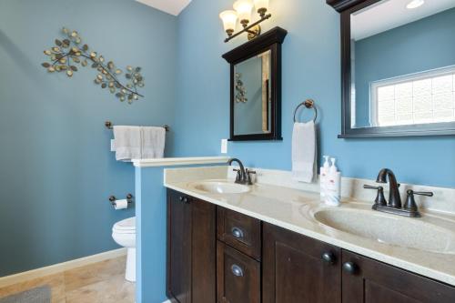 a blue bathroom with a sink and a toilet at Lux Lakehouse w/ 2 Living Areas, Screened Porch & Dock Access at 22MM in Damsel