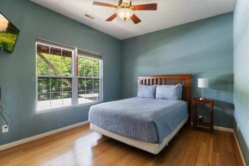 a bedroom with a bed and a ceiling fan at Lux Lakehouse w/ 2 Living Areas, Screened Porch & Dock Access at 22MM in Damsel