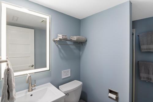 a bathroom with a white sink and a mirror at Walk to The Strip! Great Cove Water for Lake Fun in Lake Ozark