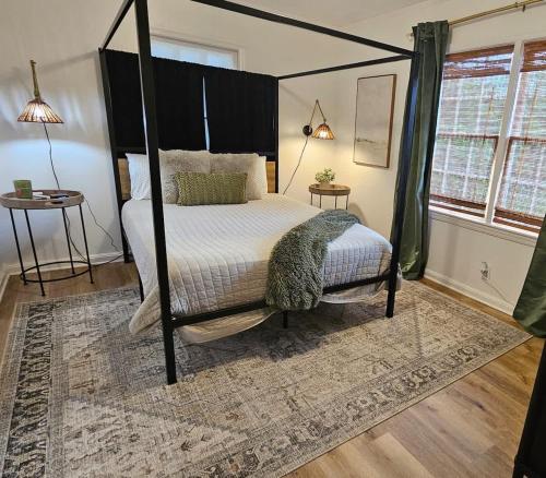 Una cama o camas en una habitación de Chic Central Bungalow close to VSU and Hospital, Game Room, 3 TVs & Fire Pit