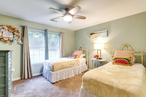 a bedroom with two beds and a ceiling fan at Walk to Lake Athens! Updated Home with Large Deck in Murchison