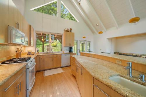 a large kitchen with wooden cabinets and a large window at Banner Elk Valley Overlook in Banner Elk