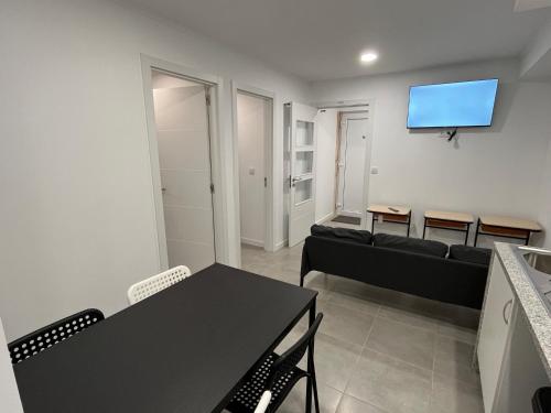 a living room with a couch and a flat screen tv at Sun House - Apartamento - Sintra in Belas