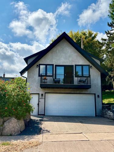 a house with a balcony on top of it at Stunning city views guesthouse in Saint Paul